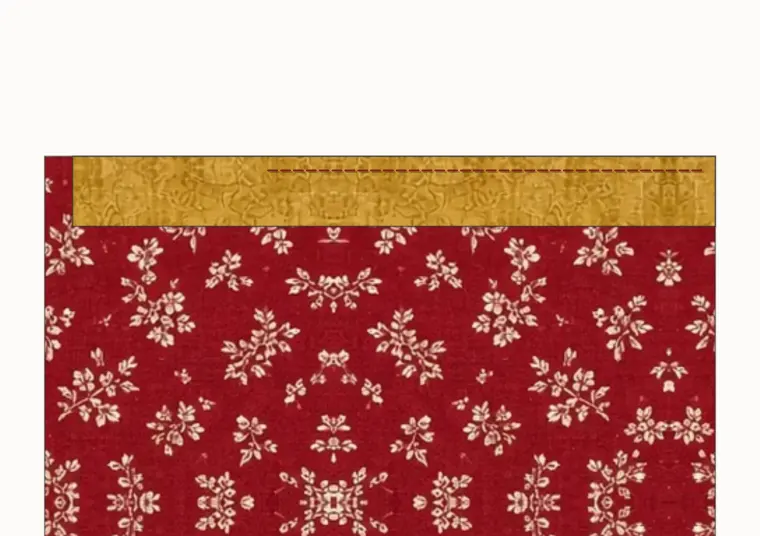 Binding laid on the front of the quilt along the top edge, sewn a quarter inch from the edge