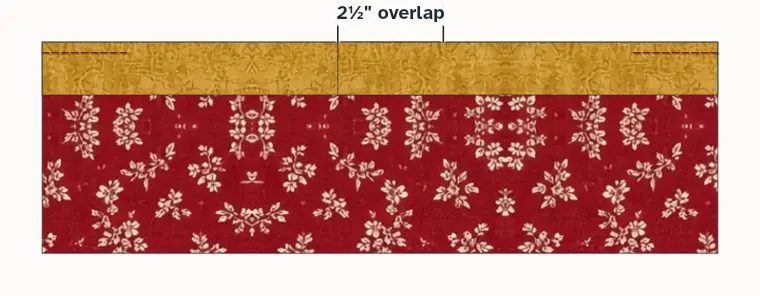 The two tails along the edge, overlapping by 2½ inches
