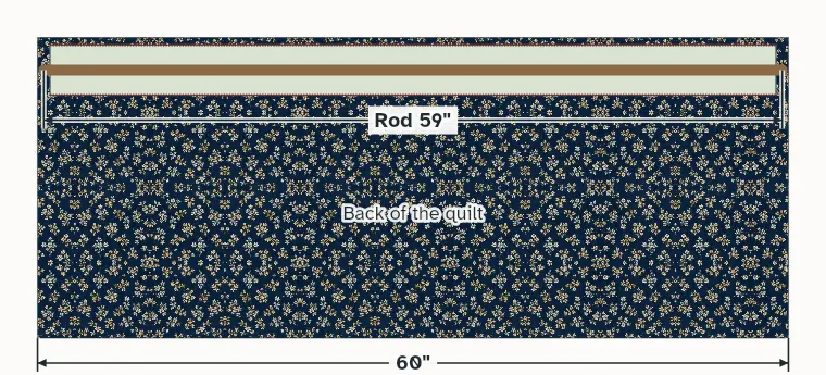 The back of the quilt with the sleeve stitched below the top edge and a rod through it